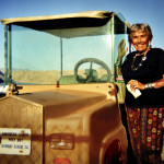 Petre Melvin and her golf cart in Bombay Beach.