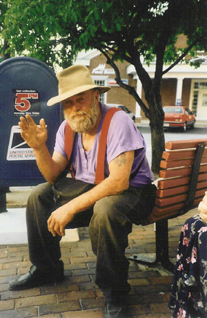 Poppa Neutrino sits on a park bench