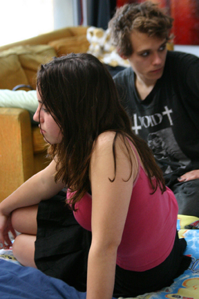 Teenage girl and her boyfriend looking distantly