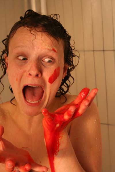 Bloody, naked woman in shower screams