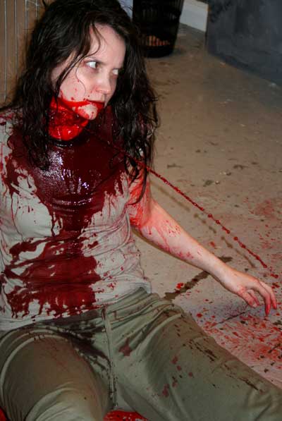 Woman covered in blood since her throat has been slit