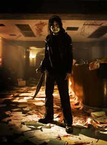 Basement Jack poses with a machete