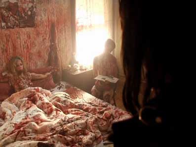 Female serial killer victim lies in a blood soaked bed