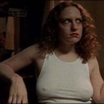 Georgia (Jordana Berliner) smokes a cigarette while wearing a white t-shirt