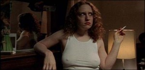 Georgia (Jordana Berliner) smokes a cigarette while wearing a white t-shirt