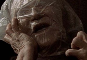 Elderly woman suffocating with a plastic bag over her head