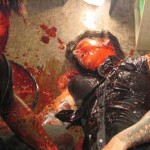 A bloody zombie and his half-eaten victim