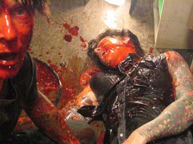 A bloody zombie and his half-eaten victim