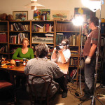 Waylon Bacon films a scene around a dinner table