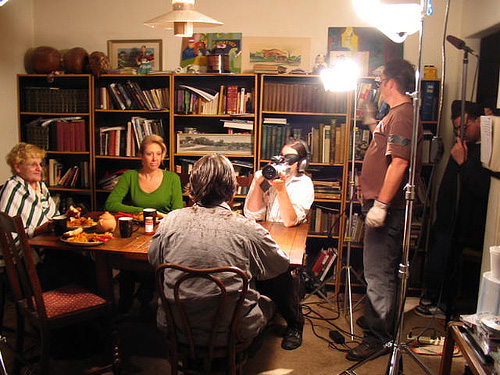 Waylon Bacon films a scene around a dinner table