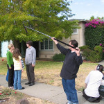 Filming a movie scene on a sidewalk