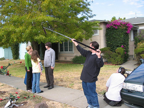 Filming a movie scene on a sidewalk