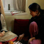 Kashmir woman teaches another about chess