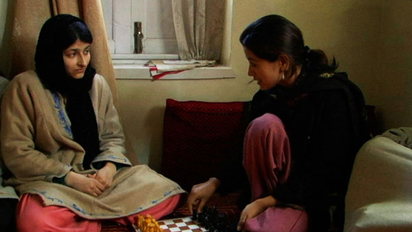 Kashmir woman teaches another about chess