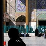 Child standing in the shadow of an Iraq shrine in Kadhimiya