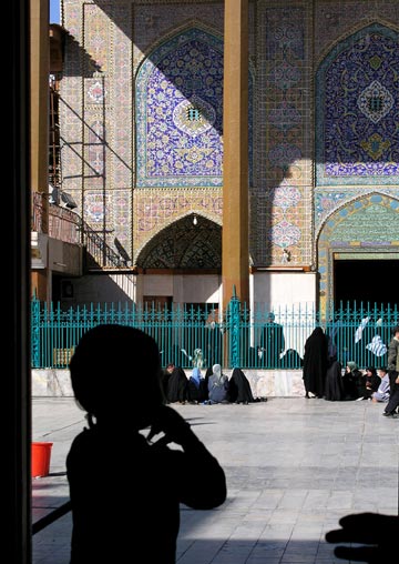 Child standing in the shadow of an Iraq shrine in Kadhimiya