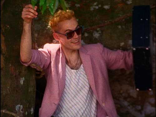 Hip young man wearing a pink blazer