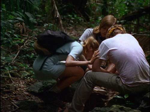 Three young adults stop to do drugs in the jungle