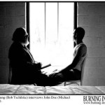 A bearded man and a young man sit in front of a hospital window