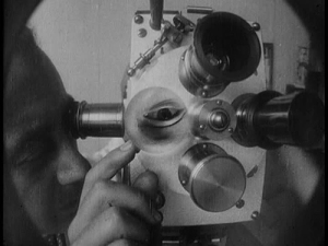 Man Ray adjusts the lens on his camera