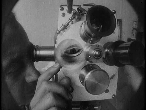 Man Ray adjusts the lens on his camera