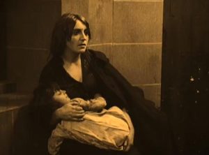 Homeless woman cradling her son
