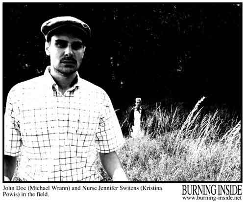 An amnesia victim and his nurse stand in a field