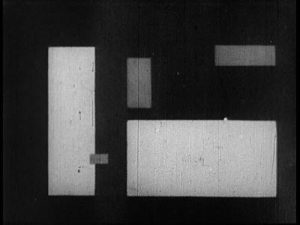 Abstract film still featuring black and white rectangles of various shapes