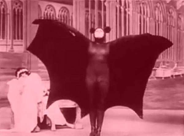 Woman in bat costume stretches her wings