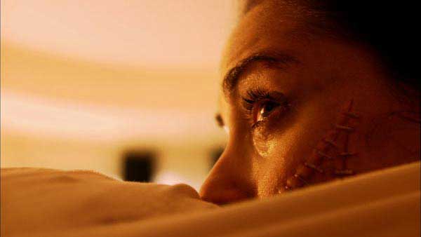 Woman cries because she is sewn to another person