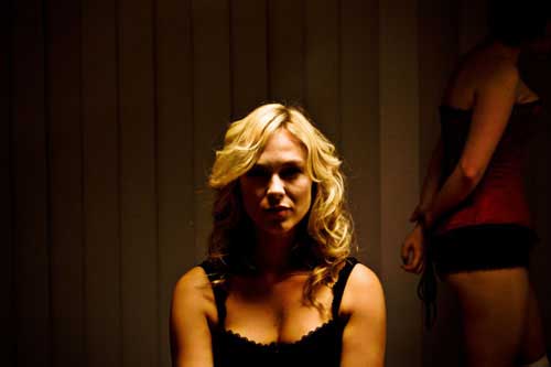 Beautiful blonde woman wearing lingerie stares at camera