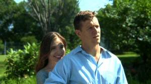 Husband and wife standing outdoors