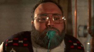 Bearded man spits out green goo