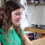 Teenage girl in green t-shirt in music store