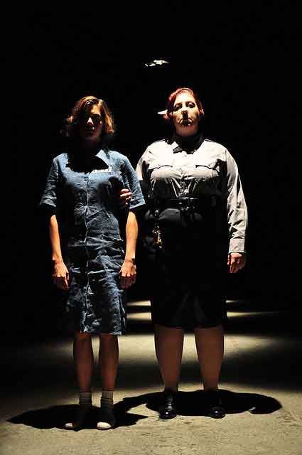 Female Night Guard walks a female prisoner to her cell
