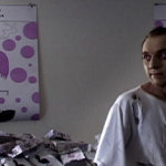 Man stands in apartment filled with cigarette boxes