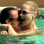 Man cuddles a woman in a swimming pool