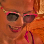 Woman wearing brightly colored sunglasses
