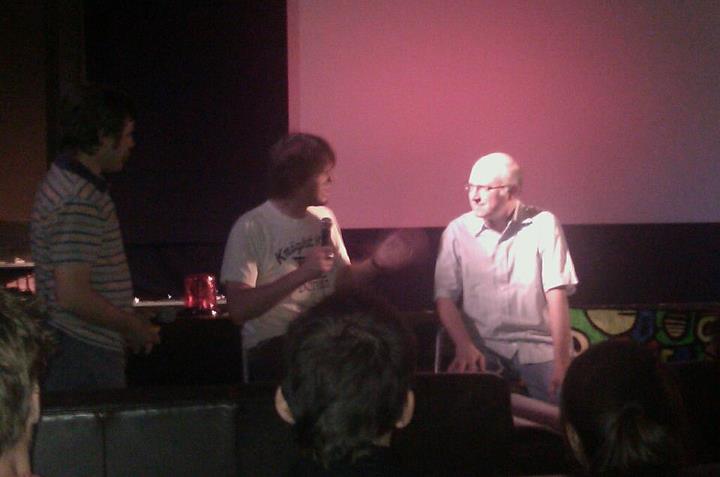 Filmmaker Jeff Krulik sits on a stage with a man named Jay