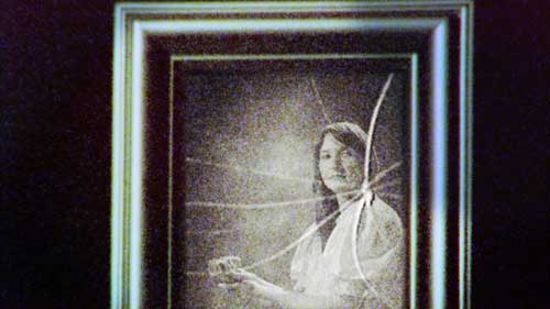Shattered old time photograph of woman