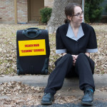 Cleaning woman sitting on the curb