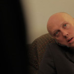 Bald man on cell phone