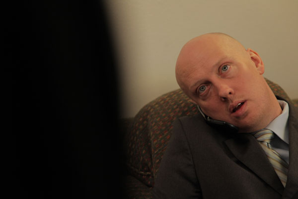 Bald man on cell phone