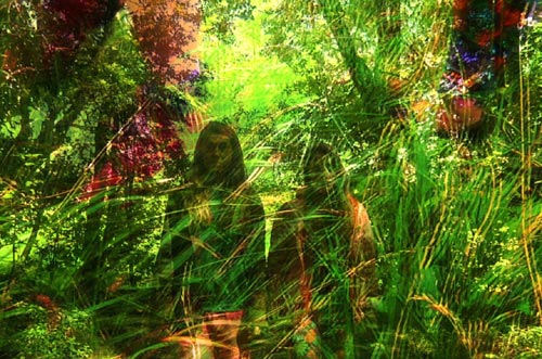 Two teenage girls blend into their forest surroundings