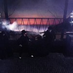 19th century men stand on a foggy bridge