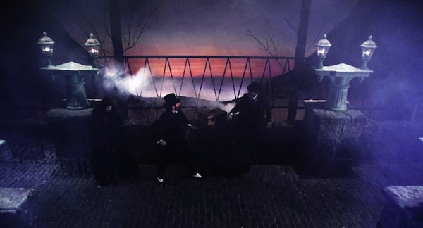 19th century men stand on a foggy bridge