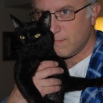 Filmmaker Jeff Krulik holds his black cat Iggy up to his face