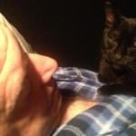 Filmmaker Jeff Krulik is sleeping while his black cat Iggy Smalls lays on his chest.