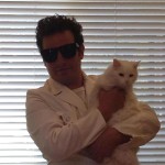 Filmmaker Mike Davis poses with his white cat named The Girl