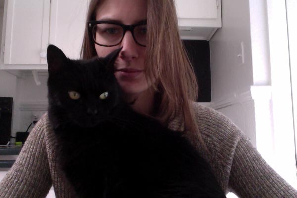 Filmmaker and dancer Élisabeth Desbiens attempts to write her next script with some help black kitty Petit-Poux.